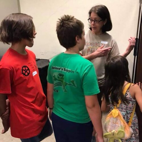 Cathy Glazener shows children Micah 6 Food Pantry