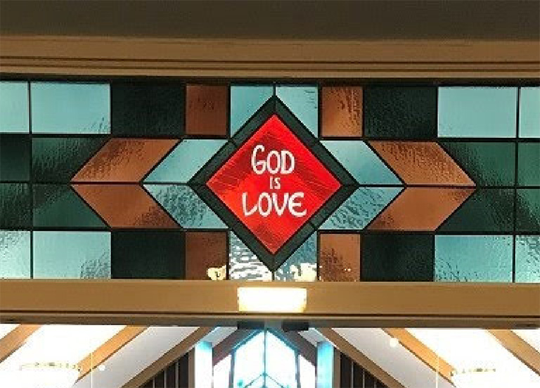 God is love stained glass window