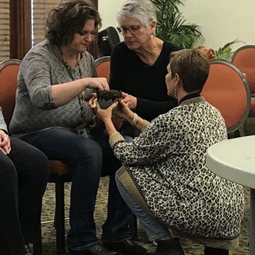 Teresa Nuckols serves communion at Womanfest