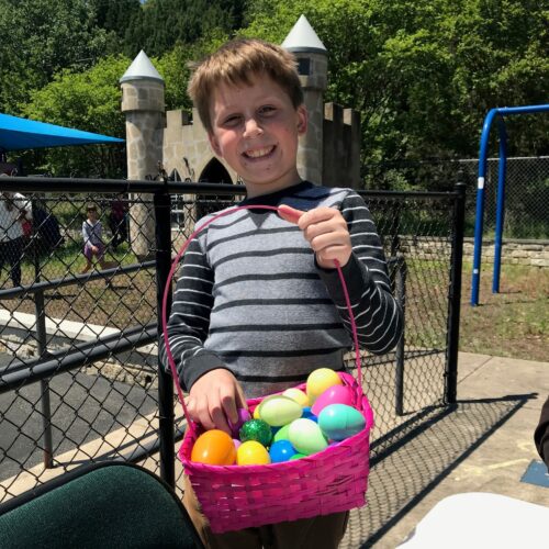 Alex Byrd with full basket at Palm Sunday Picnic & Easter Egg Hunt