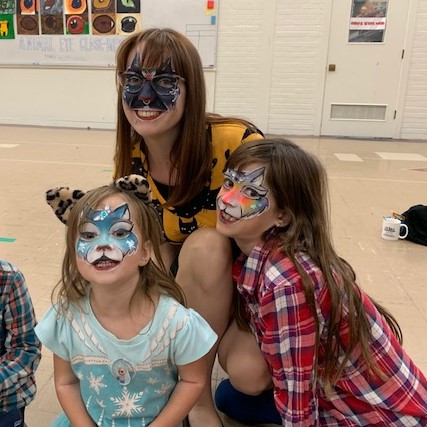 Hannah, Katalina, and Thyra Neas with faces painted at Harvest Festival