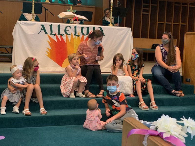 the kids listen to the children's sermon from Abby Byrd on the altar steps