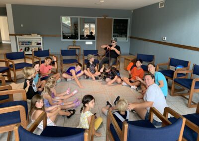 VBS kids play a game with string