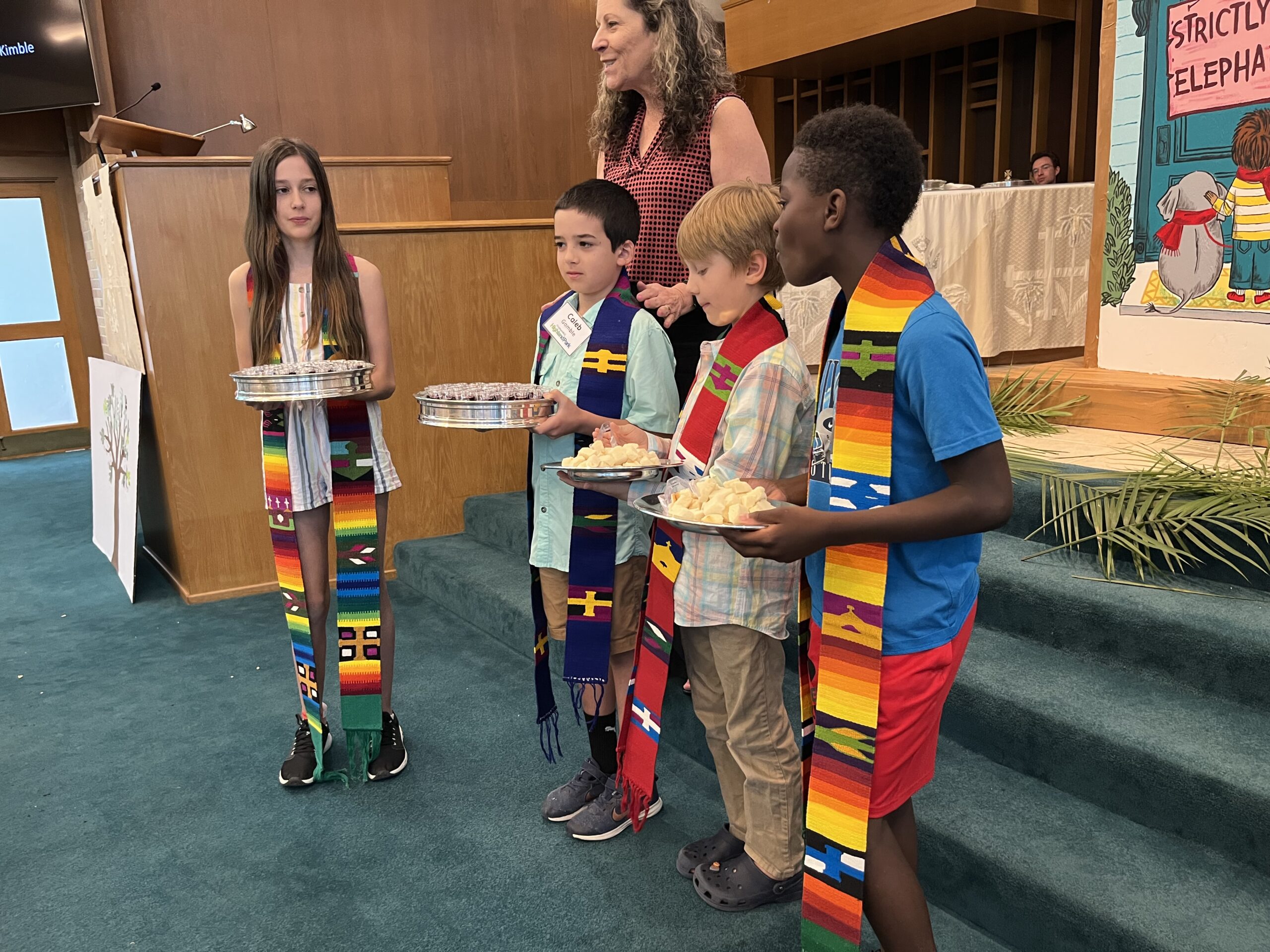 children serving communion