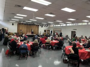 People sit at their tables at HP's annual Plum Pudding Festival 2024